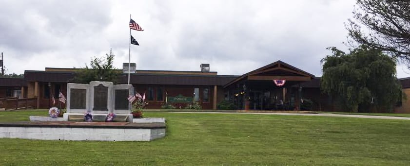 Exterior view of Parker Personal Care Facility with flags