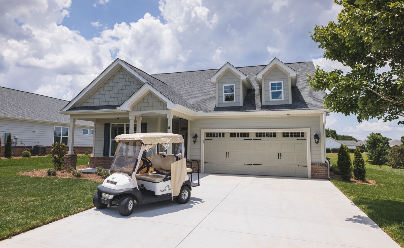 Exterior view of a senior living facility with a golf cart