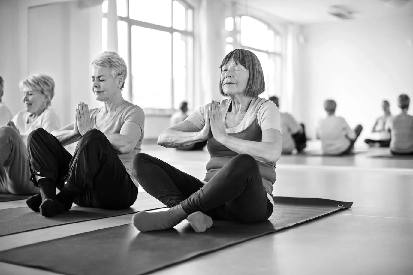 Residents participating in a yoga class in an activity room
