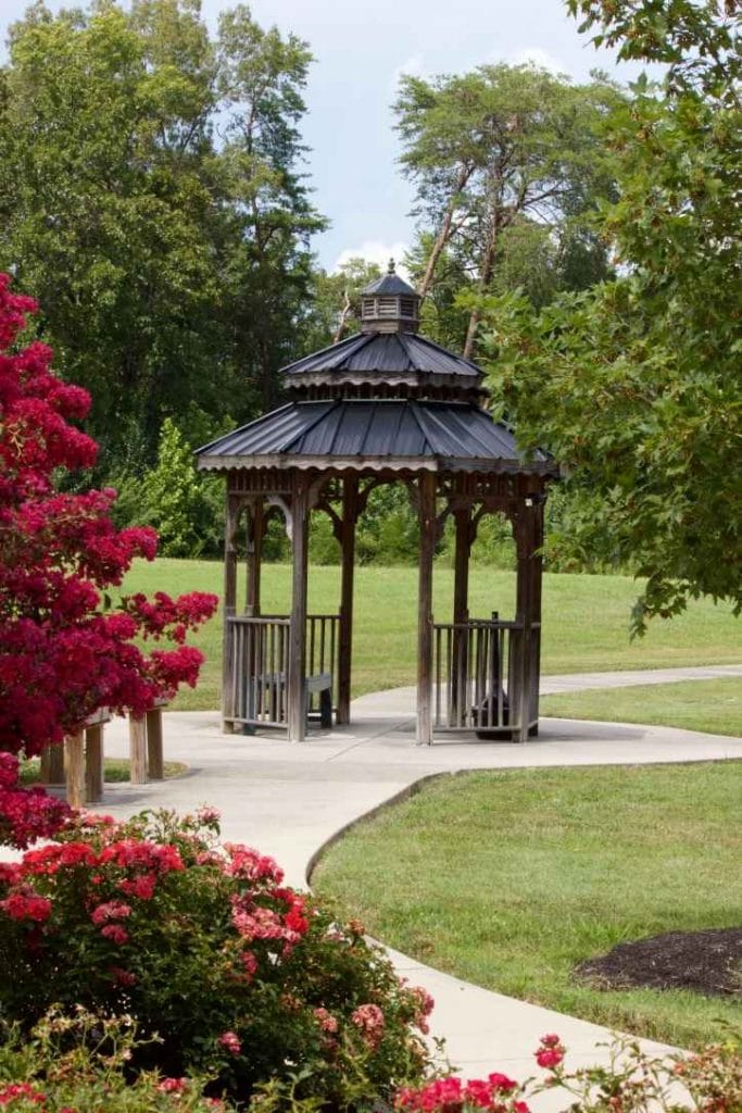 A gazebo surrounded by blooming flowers in an outdoor space