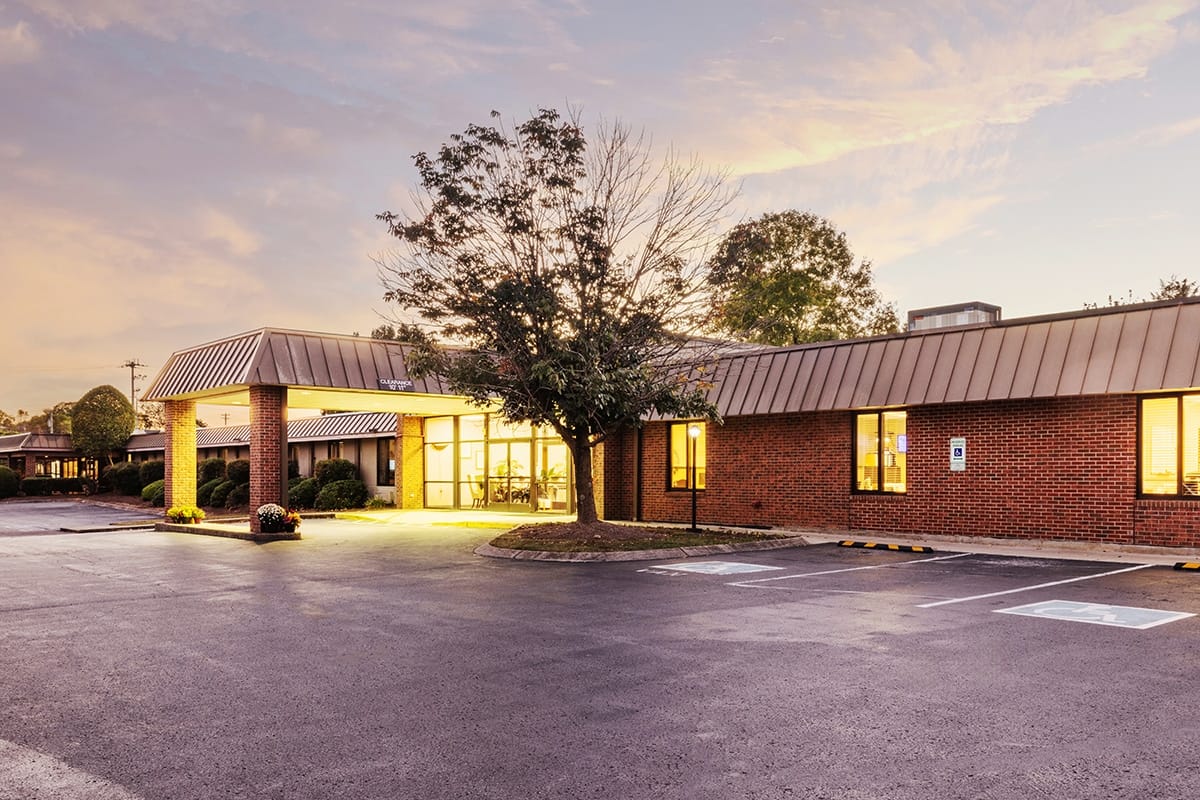 Exterior view of Alta Heights Post Acute facility at sunset