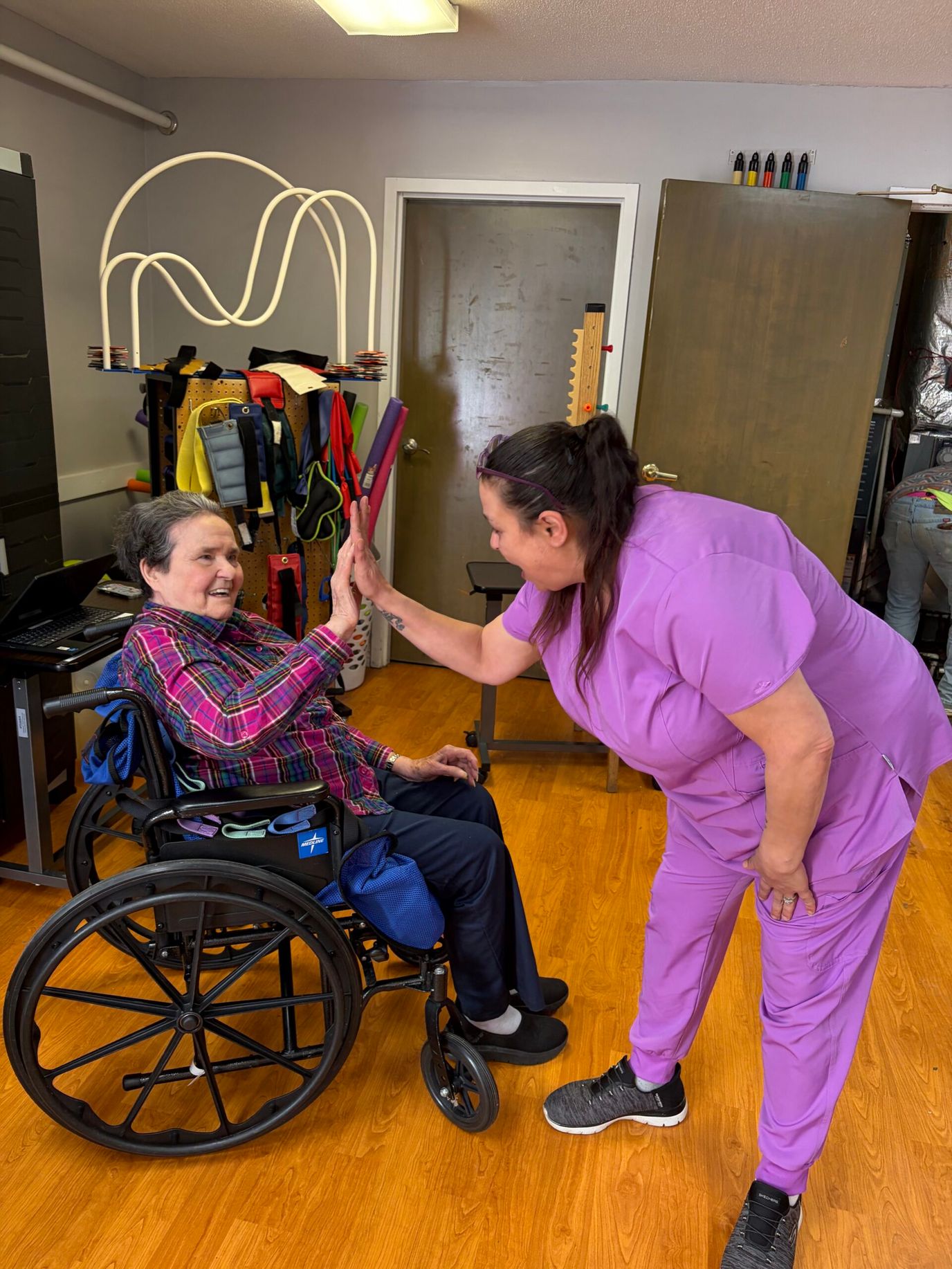 A staff member interacting with a resident in a common area