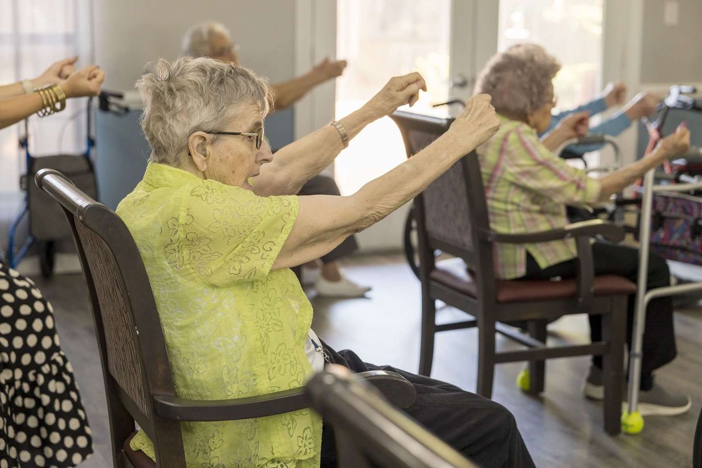 Residents participating in a seated exercise class