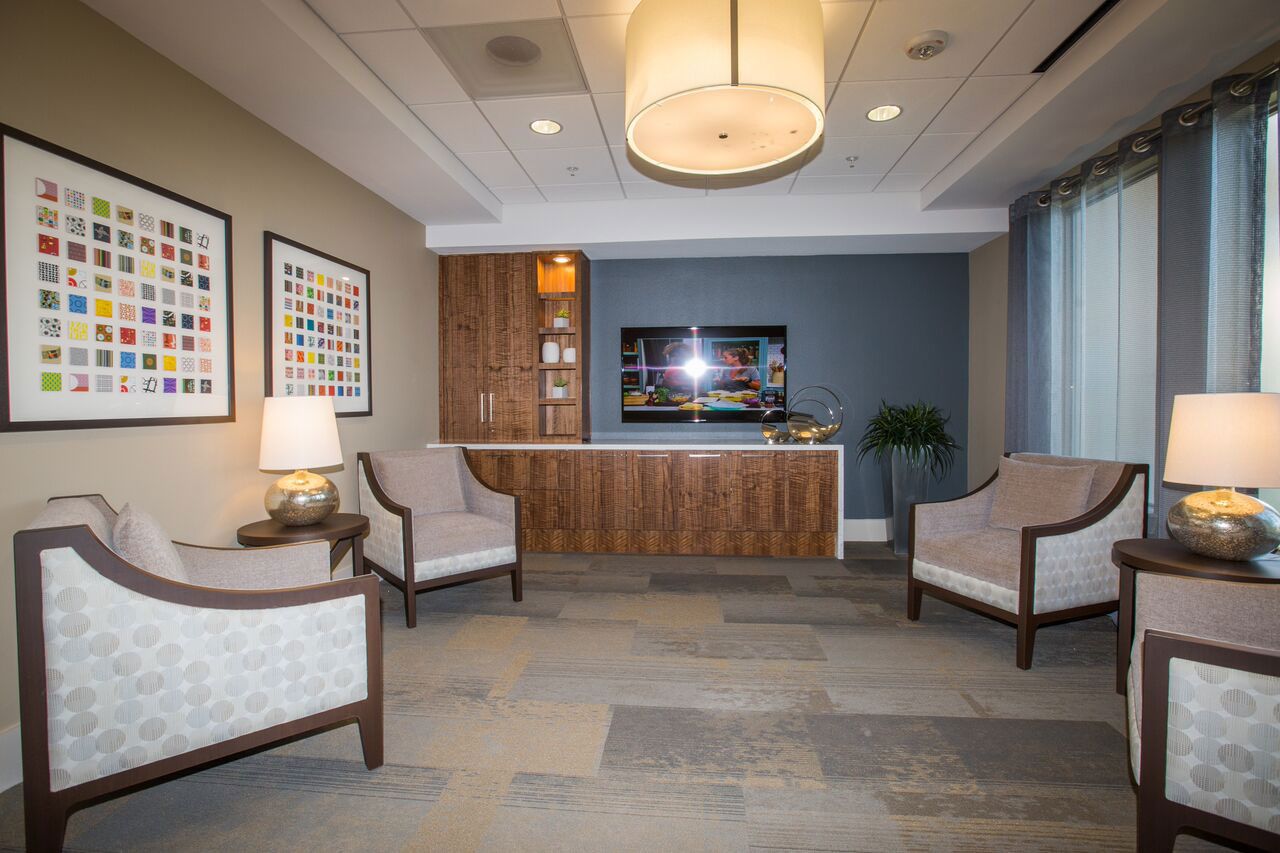 A cozy common area with chairs and artwork