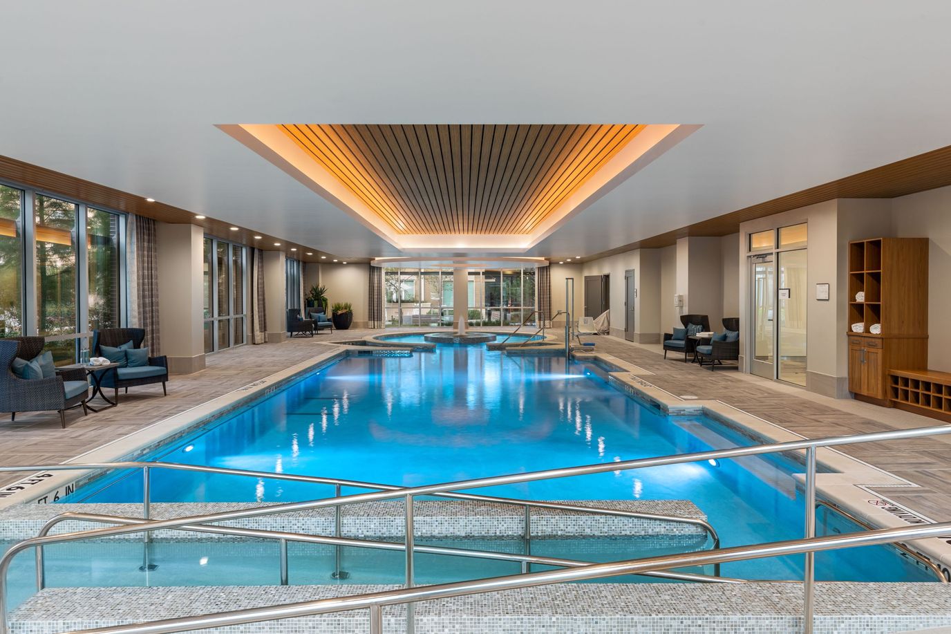 Indoor swimming pool area with lounge seating