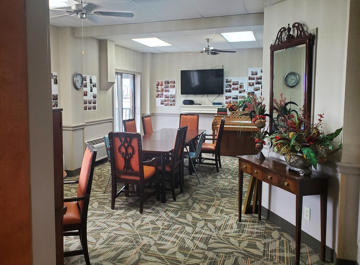 A common area with tables and chairs in a warm setting