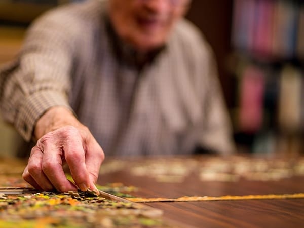 Resident engaged in a puzzle activity at a table