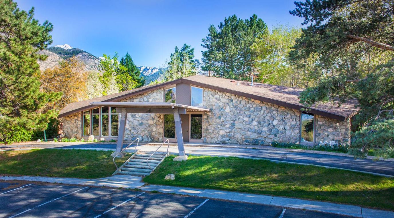 Exterior view of a stone building among trees