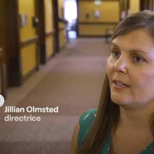 Director speaking in a facility hallway