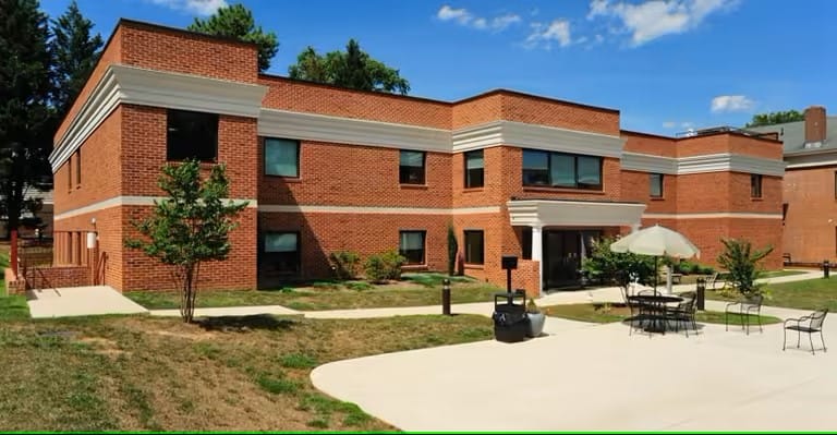 Exterior view of a brick building with outdoor seating