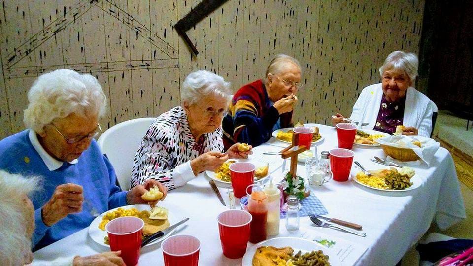 Residents enjoying a meal together at a dining table