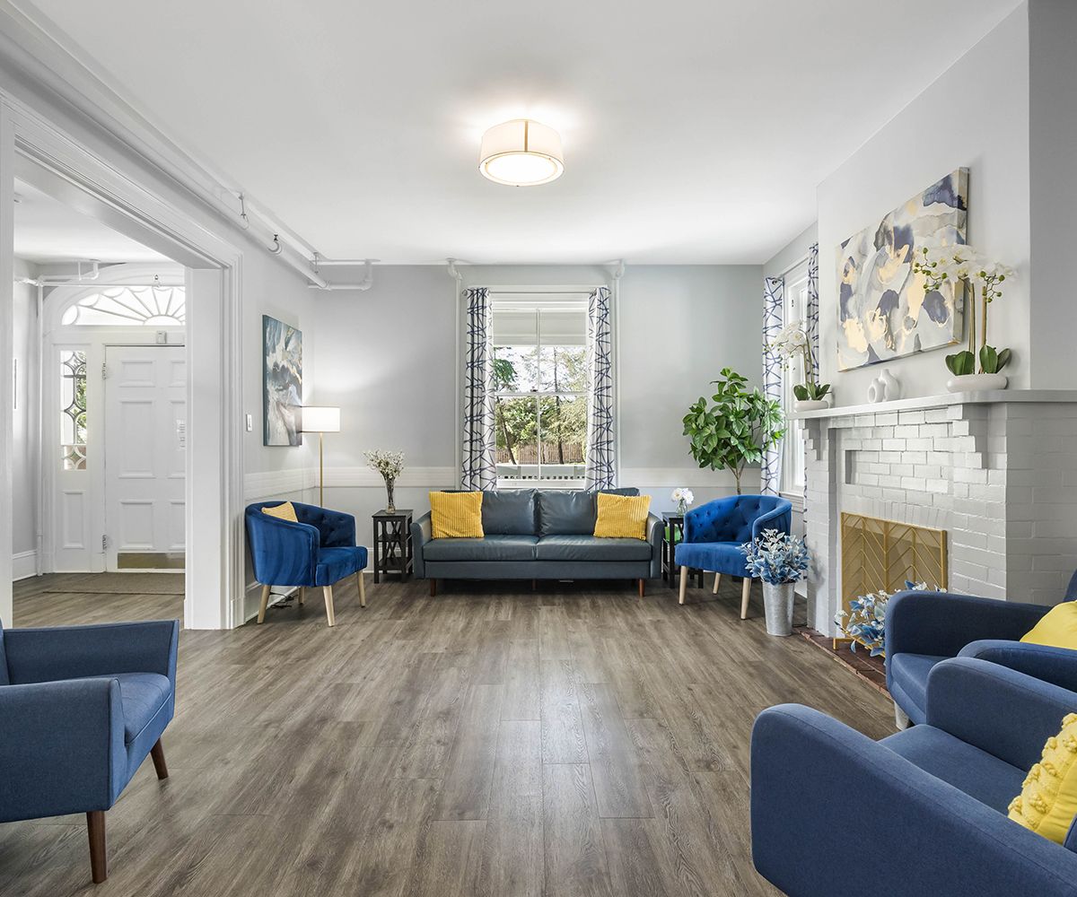 Bright and inviting lounge area with blue sofas and artwork