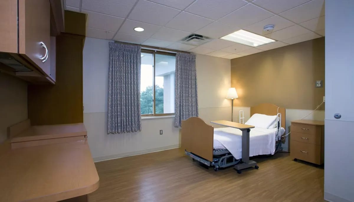 Private resident room with hospital bed and window