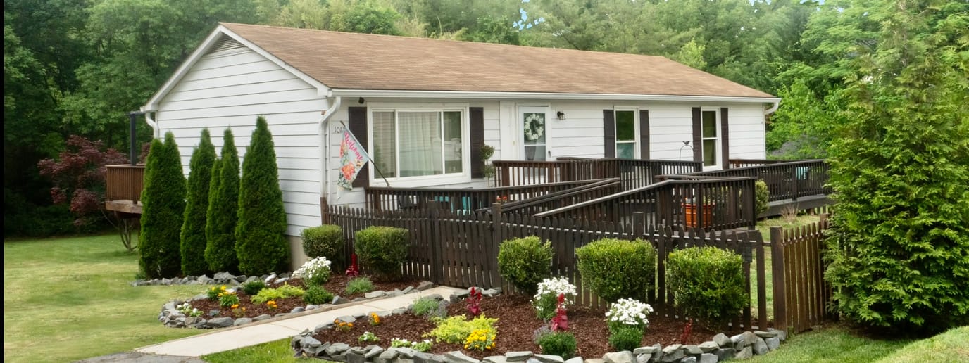 Exterior view of Evergreen Gardens building with garden area