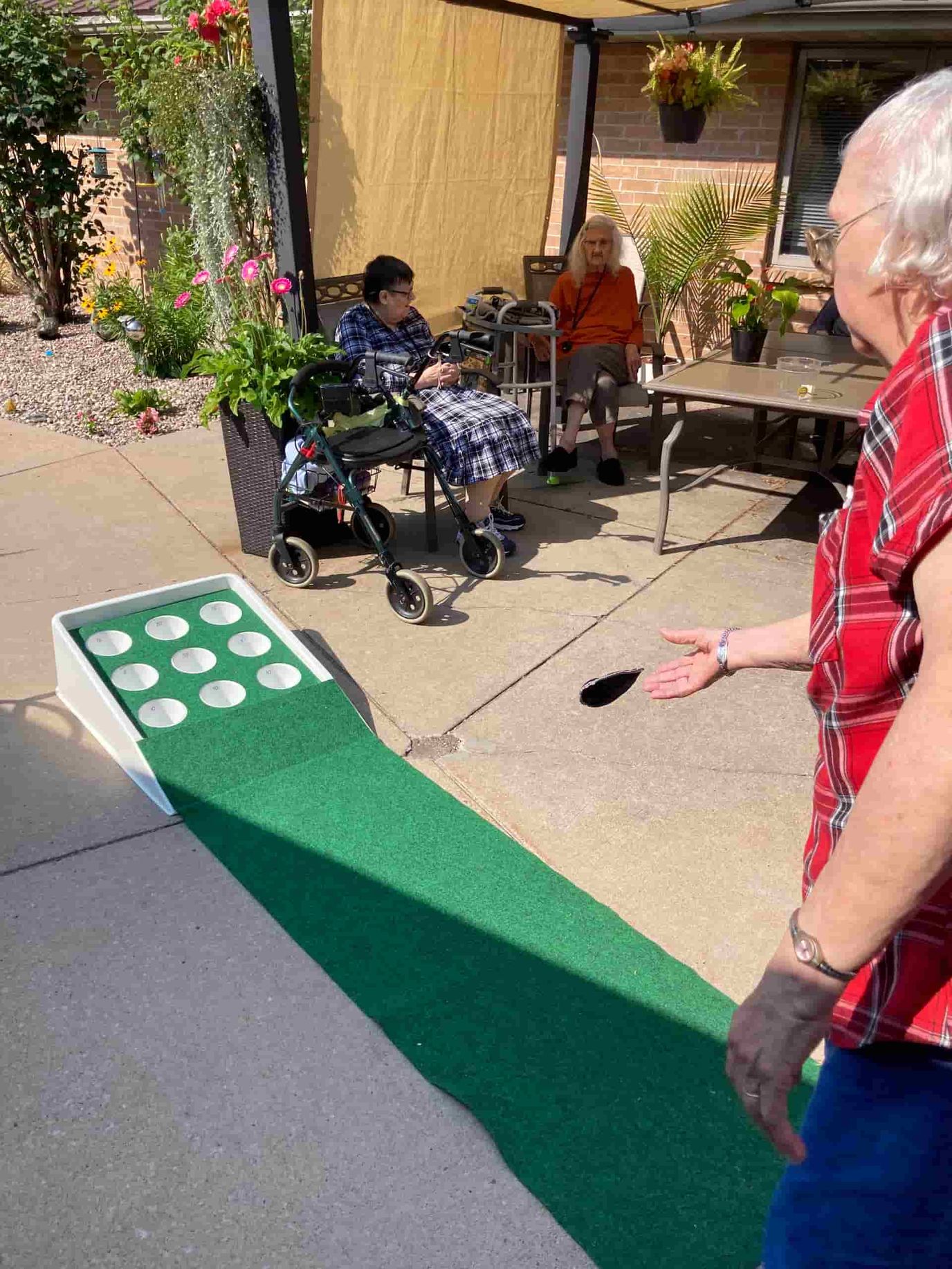 Residents enjoying a game outdoors on a sunny day