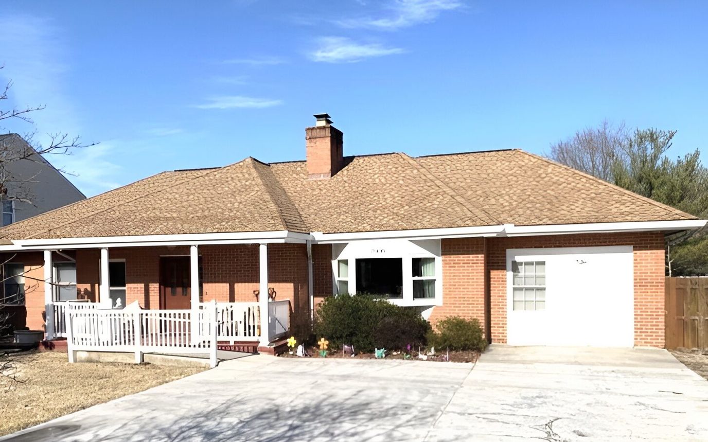 Exterior view of a single-story facility with a porch