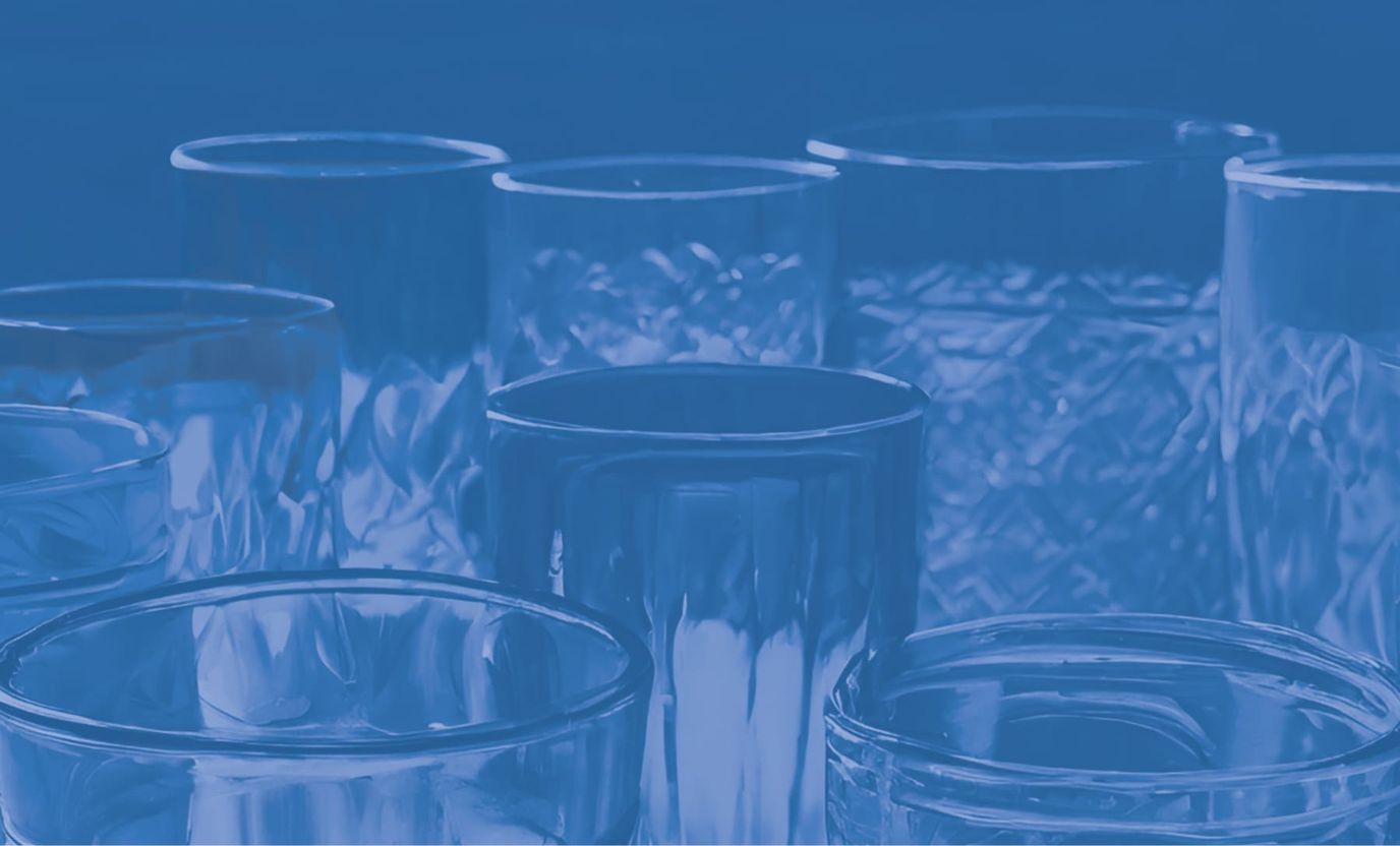 Close-up of various glassware on a blue background