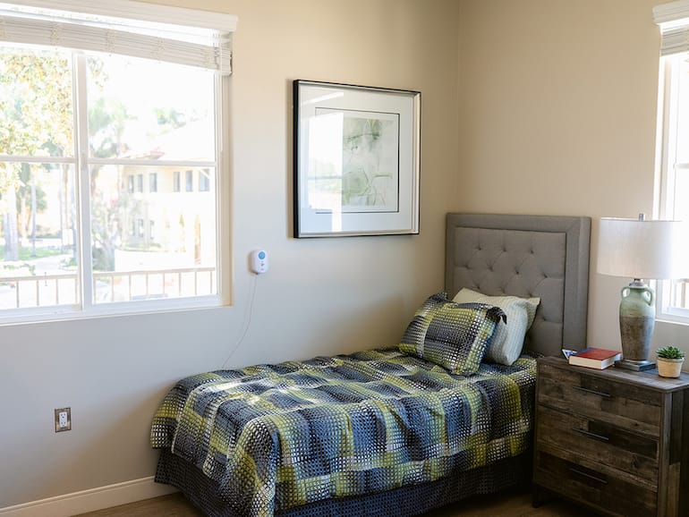 Cozy private resident room with a bed and artwork