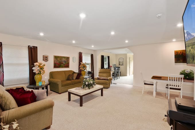 Cozy living room with couch, coffee table, and art.