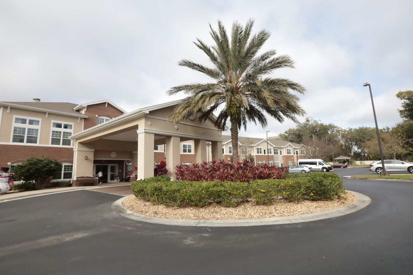 Exterior view of the facility entrance with palm trees