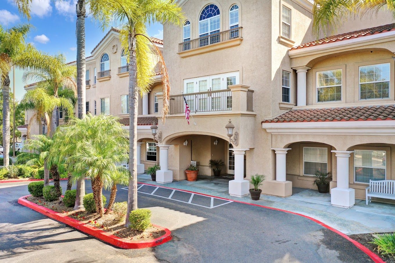 Exterior view of Bayshire Torrey Pines with palm trees