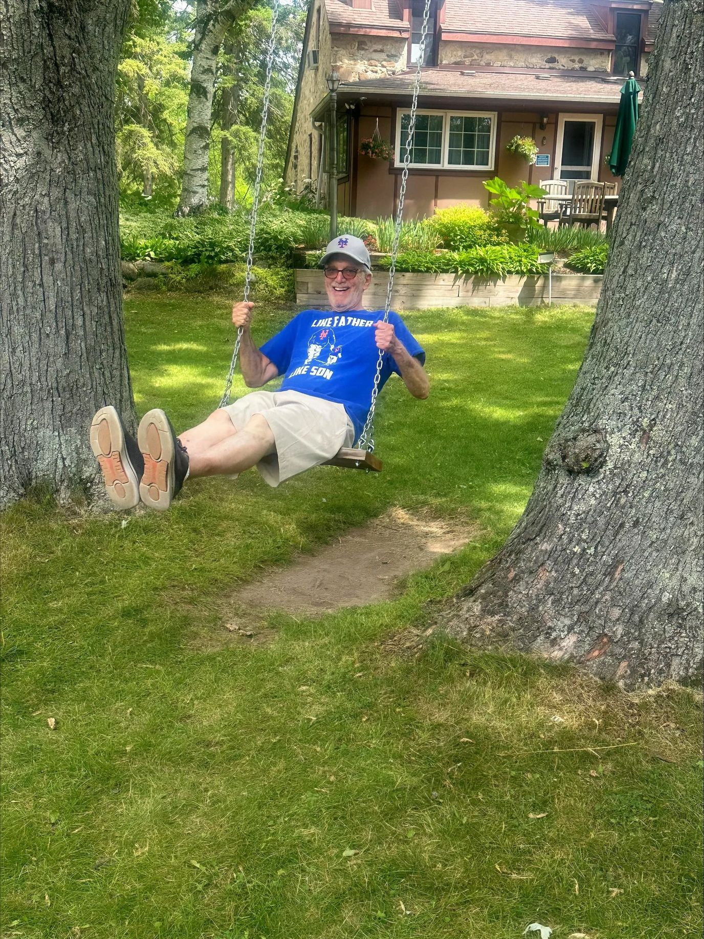 A resident enjoying a swing in the garden
