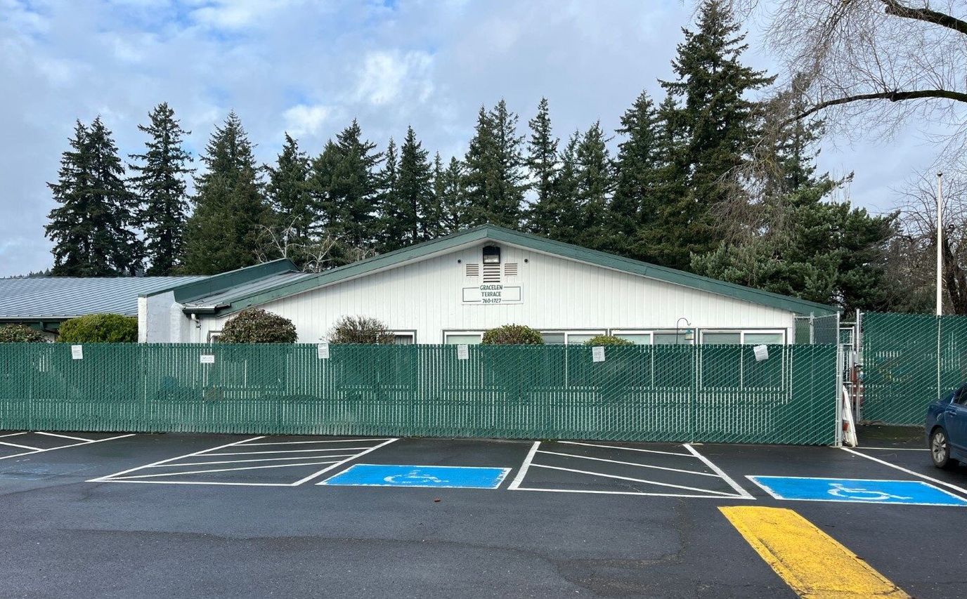 Exterior view of the facility building surrounded by trees