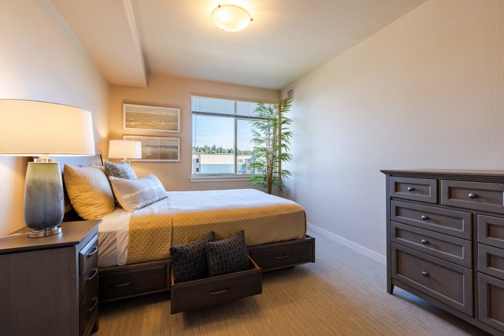 Brightly decorated resident room with bed and furniture