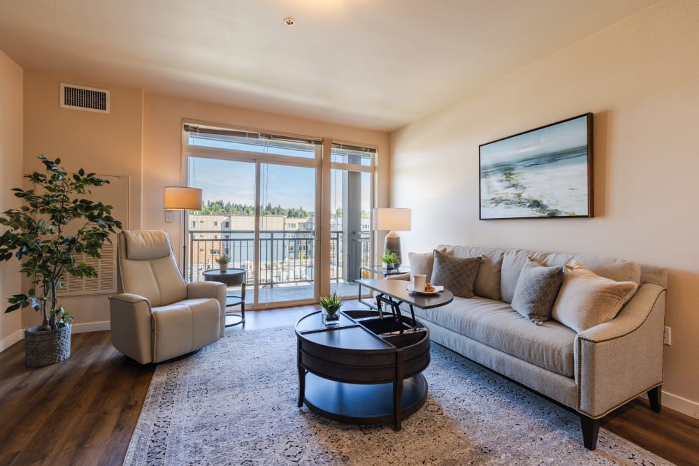 Cozy living room with balcony and modern decor.