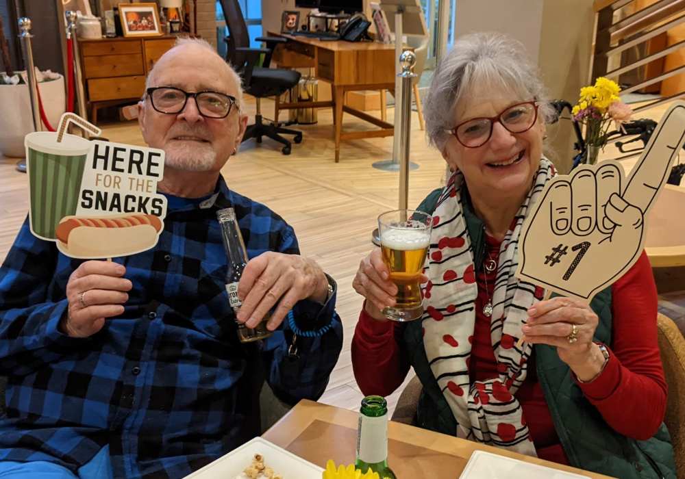 Two residents enjoying snacks and drinks together.