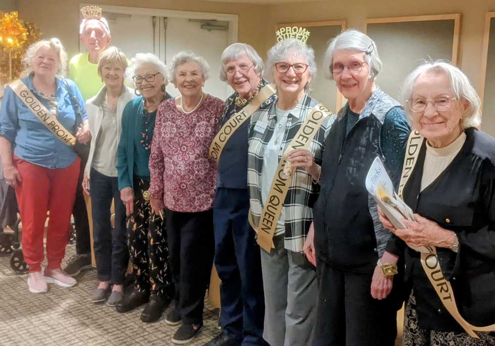 Residents celebrating with sashes at an event.