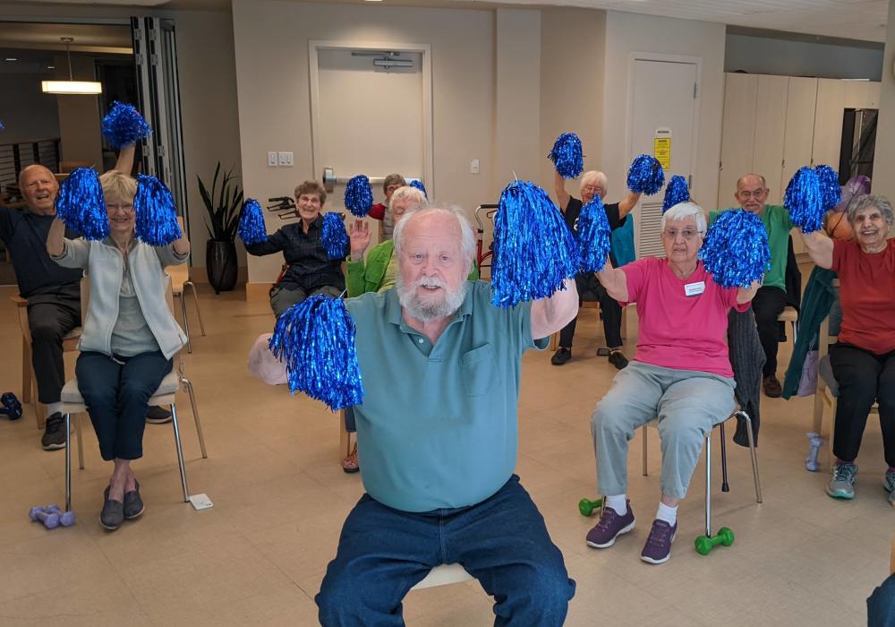 Seniors participating in an activity with pom-poms.