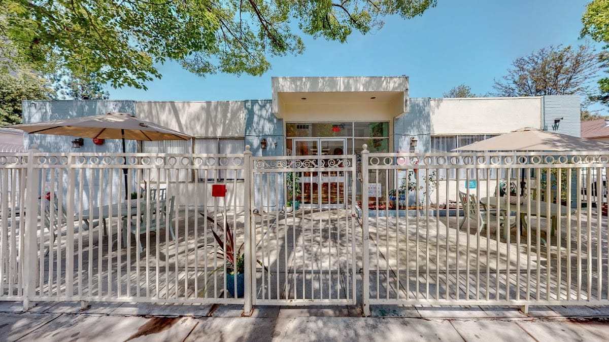 Exterior view of Angels Nursing Center with outdoor seating