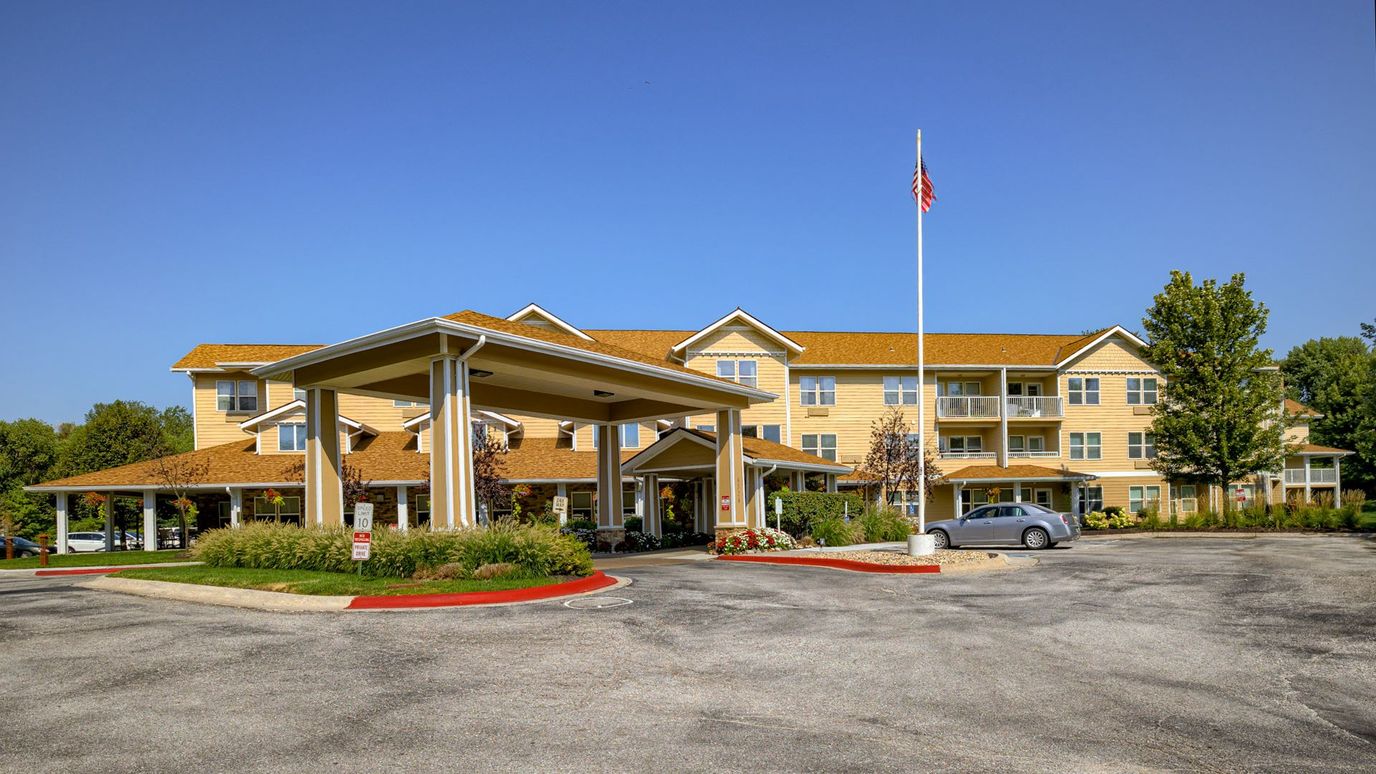 Exterior view of a senior living facility with garden and entrance