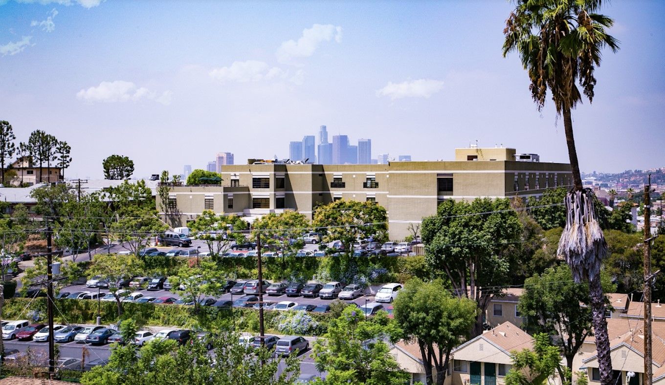 Exterior view of a healthcare center with palm trees