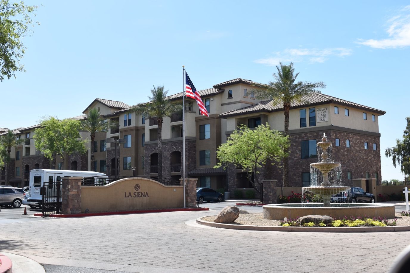Exterior view of La Siena facility with fountain and flag