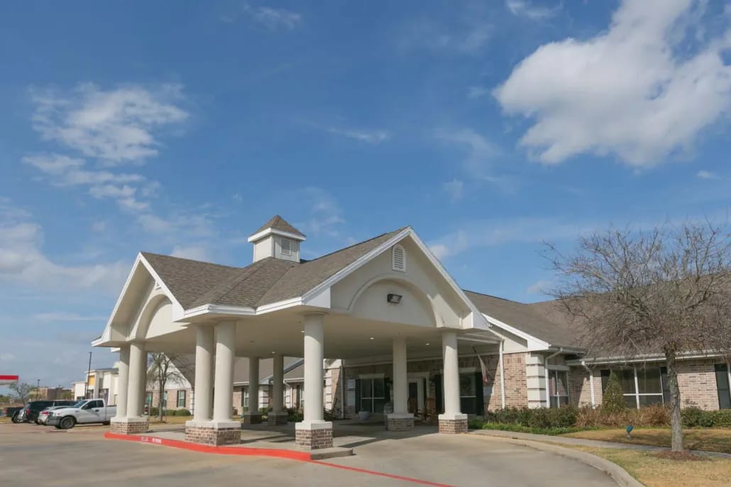Exterior view of the facility entrance with columns and signage