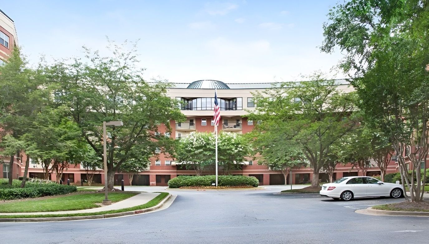 Exterior view of the facility with trees and flag