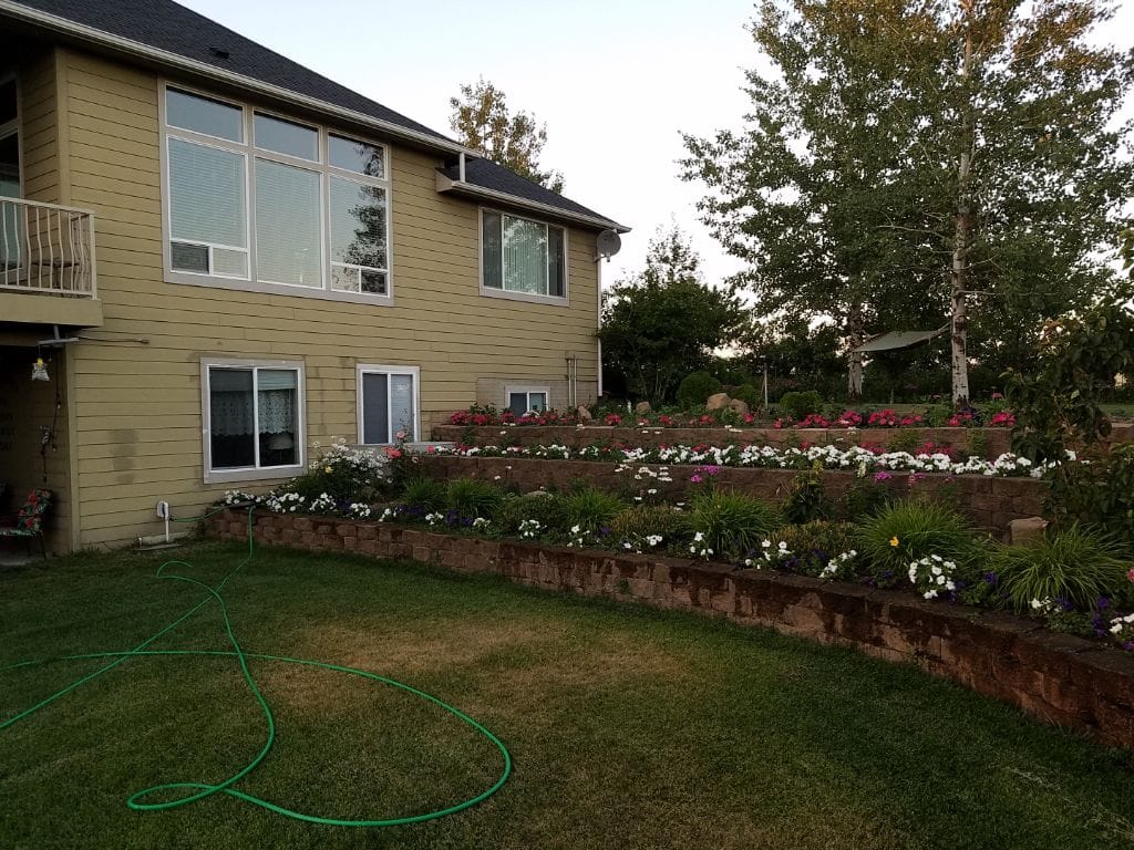 View of the back exterior and garden area of a facility