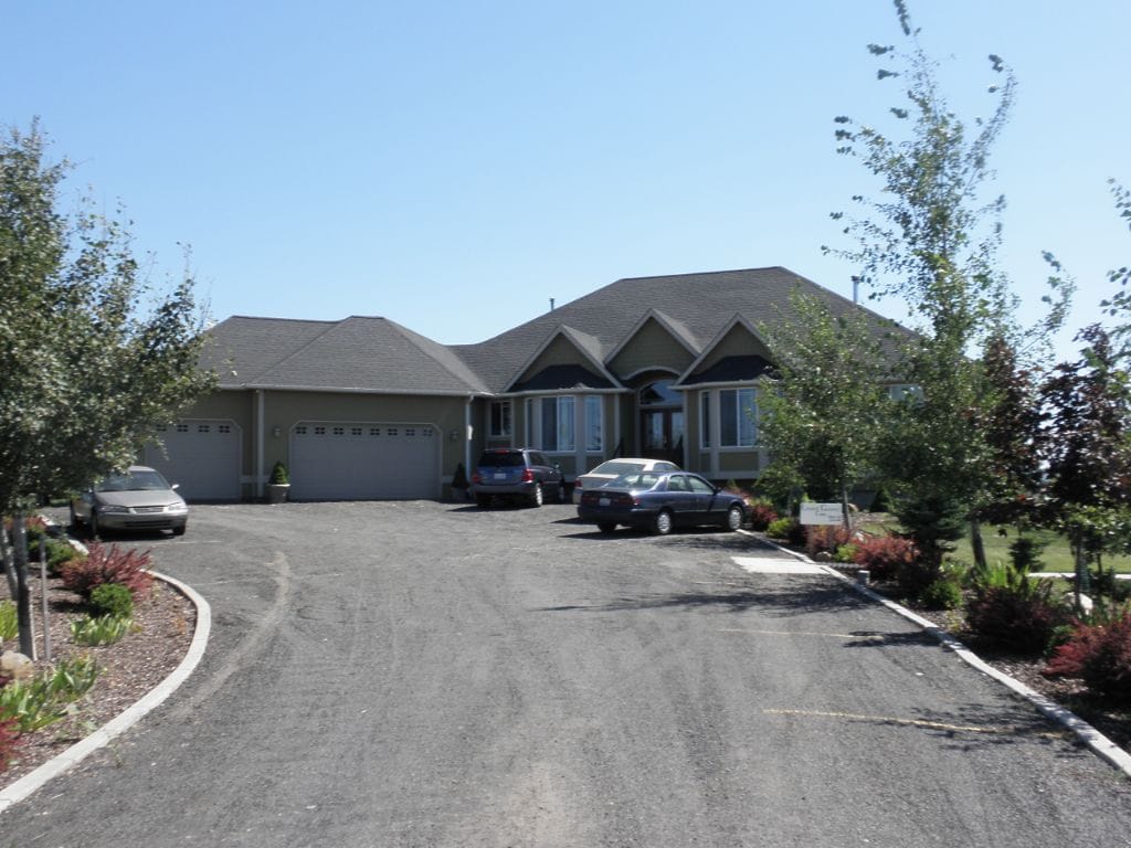 Exterior view of a senior living facility with parking