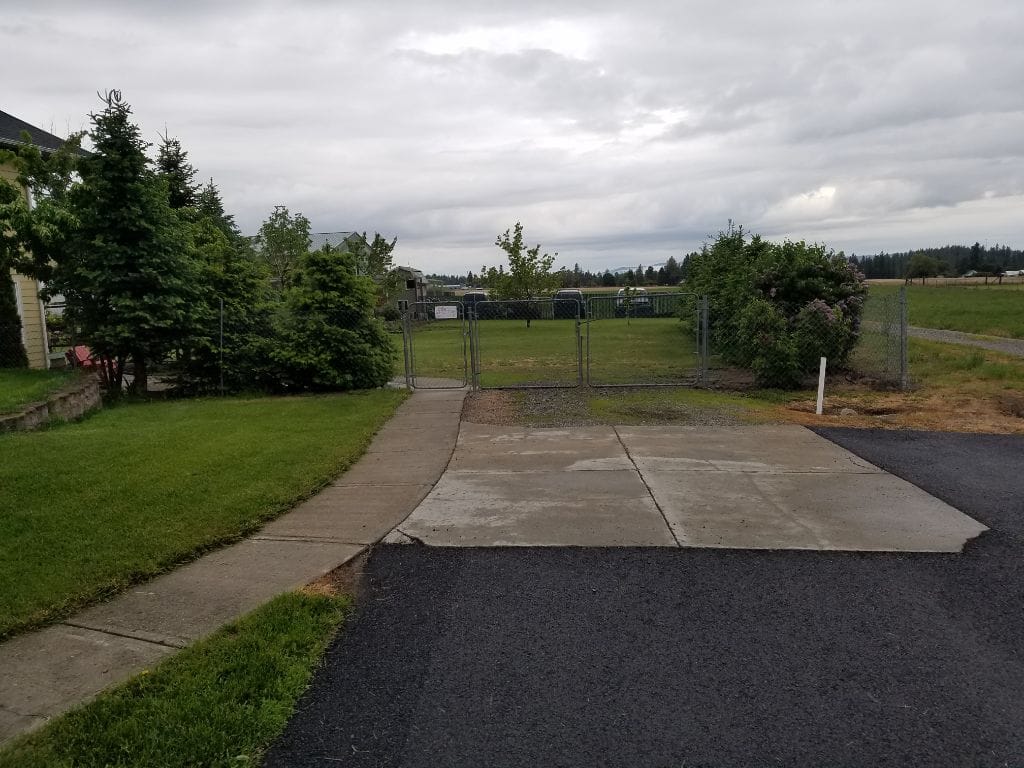 Outdoor space with a fenced area and grass