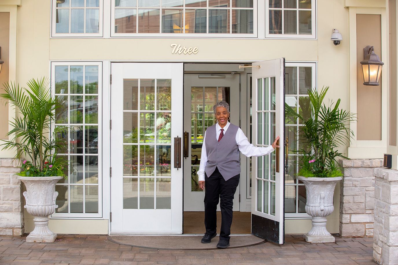 Staff member welcoming at the entrance of the facility