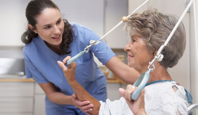 Staff assisting a senior resident in therapy