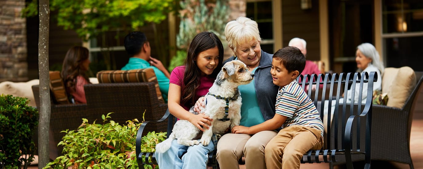 Residents enjoying time with family and a dog