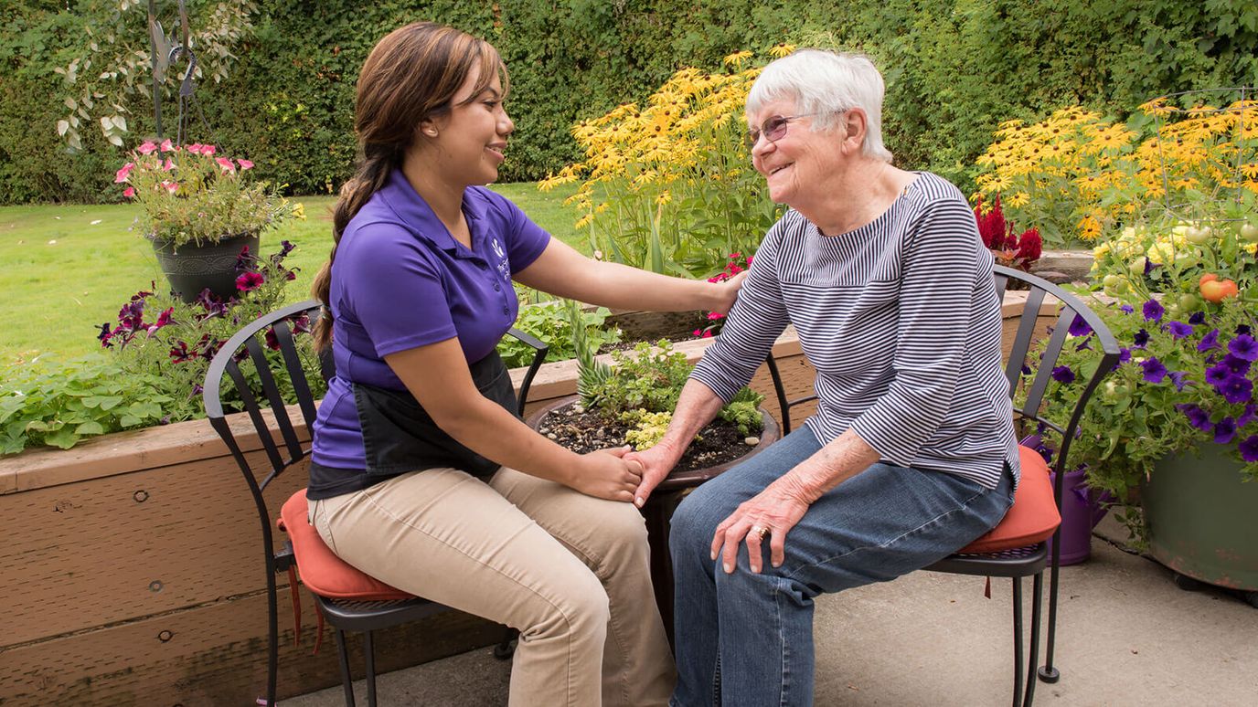Staff member and resident in a garden