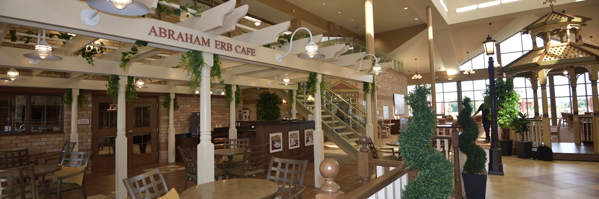 Interior view of a dining area with cafe signage.