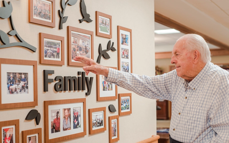 Resident interacting with a family photo display.