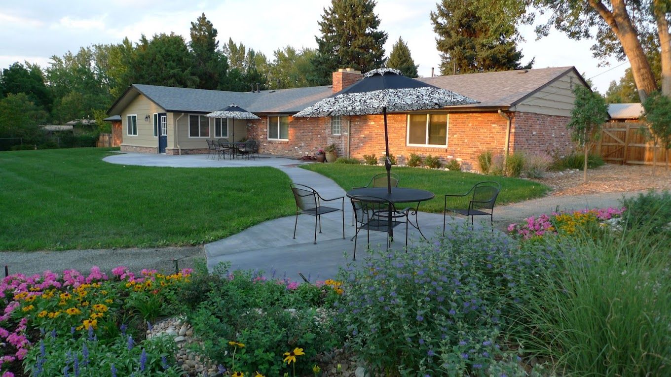 Outdoor seating area with tables and umbrellas in a garden
