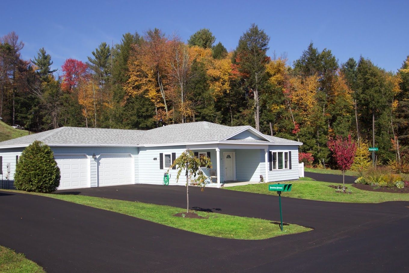 Exterior view of a single-story building with fall foliage