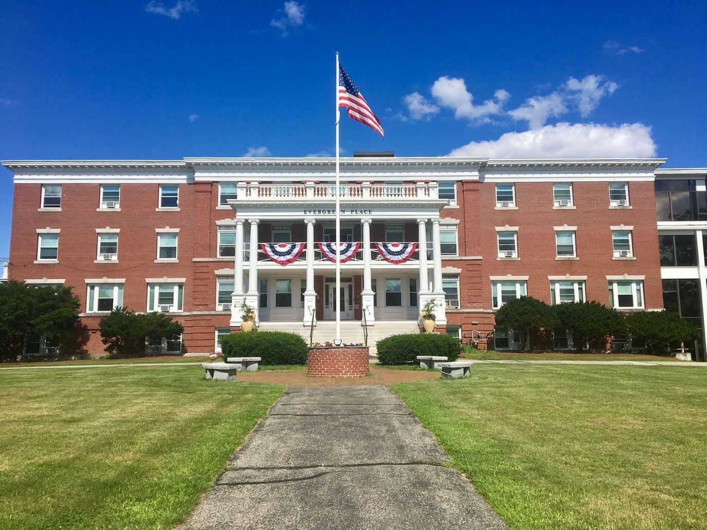 Exterior view of Evergreen Place with American flag